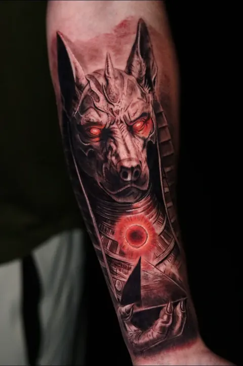 Anubis — Dark realism with a single point of red.